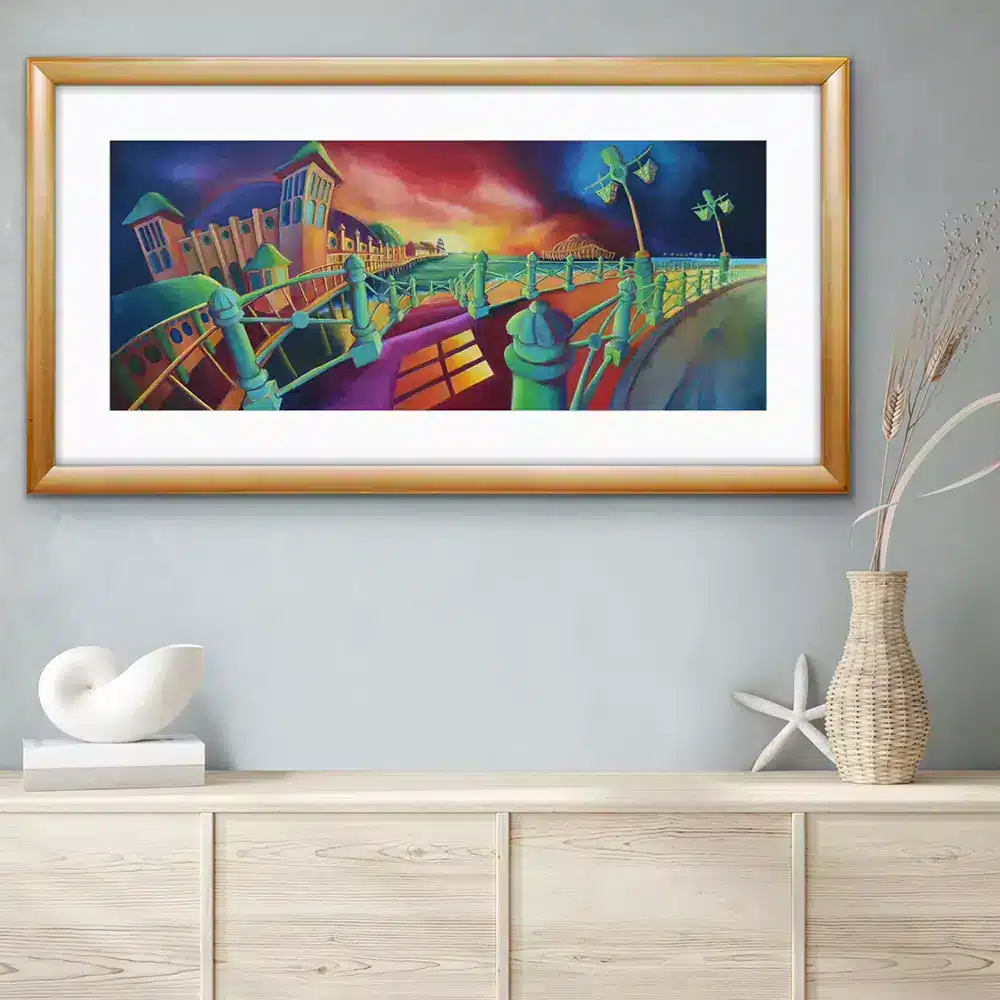 promenade-limited-edition-print--hanging-in-a-room Promenade limited edition print featuring Brighton pier and the west pier against a sunset hanging in a sophisticated interior setting. Work by Simon Wright